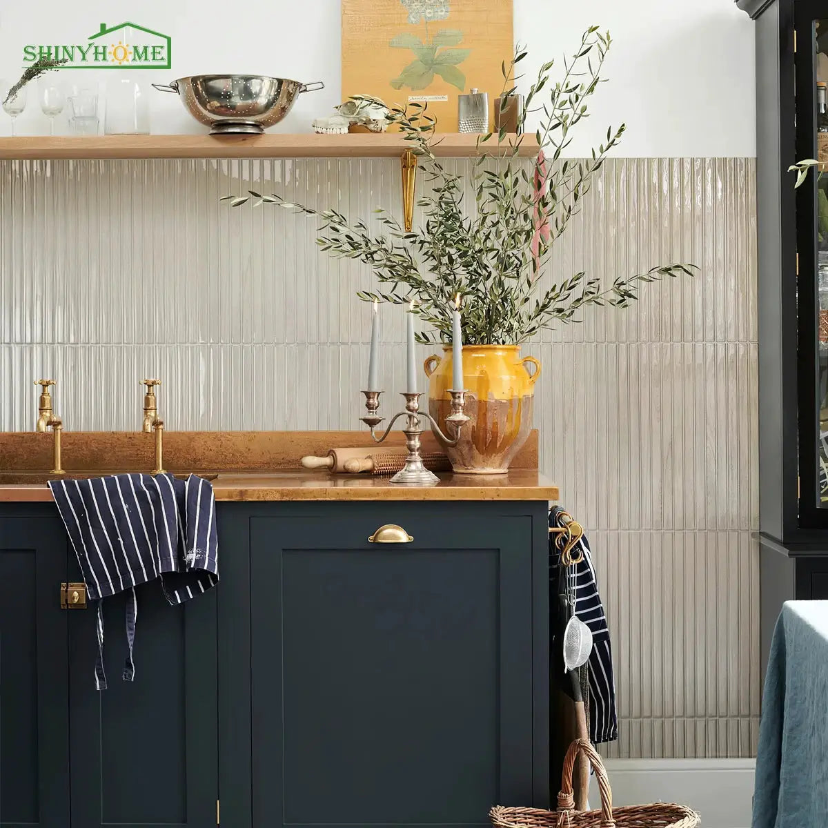 Wood grain peel-and-stick backsplash tiles in light beige, installed on a navy kitchen wall with brass fixtures and decor.