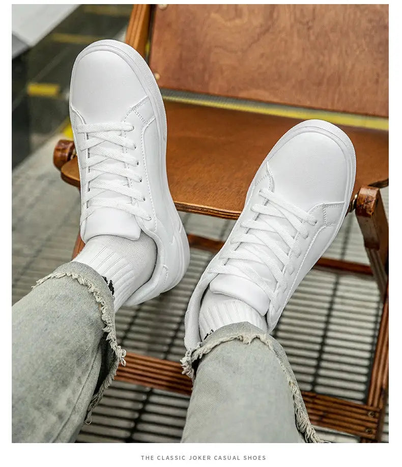 White PU leather men's sneakers with laces, casual vulcanized style shown on ripped jeans