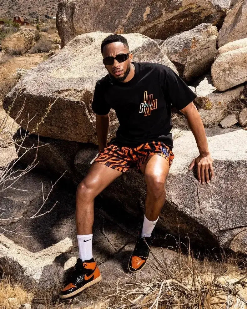 Mens motorcycle shorts with orange tiger-print pattern and quick-dry breathable mesh.