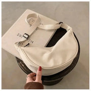 Nylon dumpling bag in white, lightweight crossbody with adjustable cream strap by Simples Market