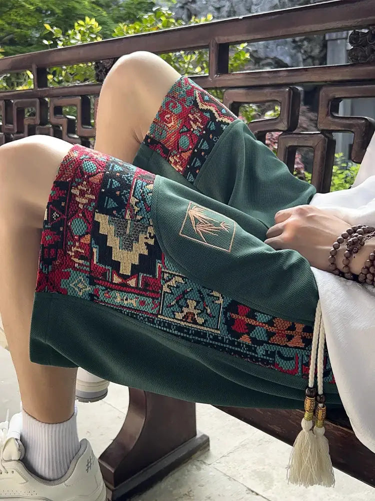 Men's ethnic embroidery shorts by Simples Market, green with multicolor geometric pattern and pockets.