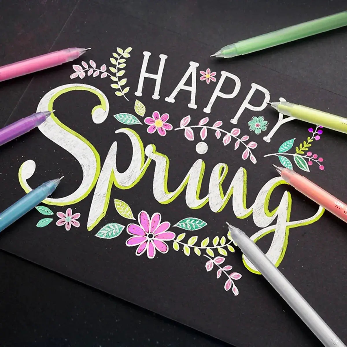 12-color gel pen set by Simples Market with fine 0.5mm tips, shown around floral chalkboard art on black paper