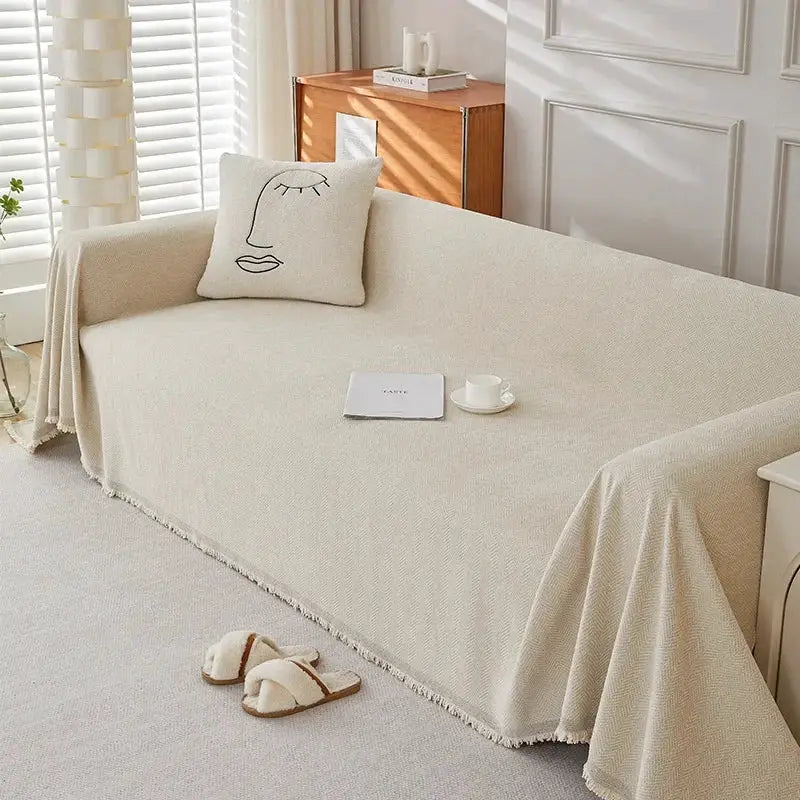 Couch cover in beige chenille with fringe, heavyweight, herringbone texture for sofa by Simples Market.