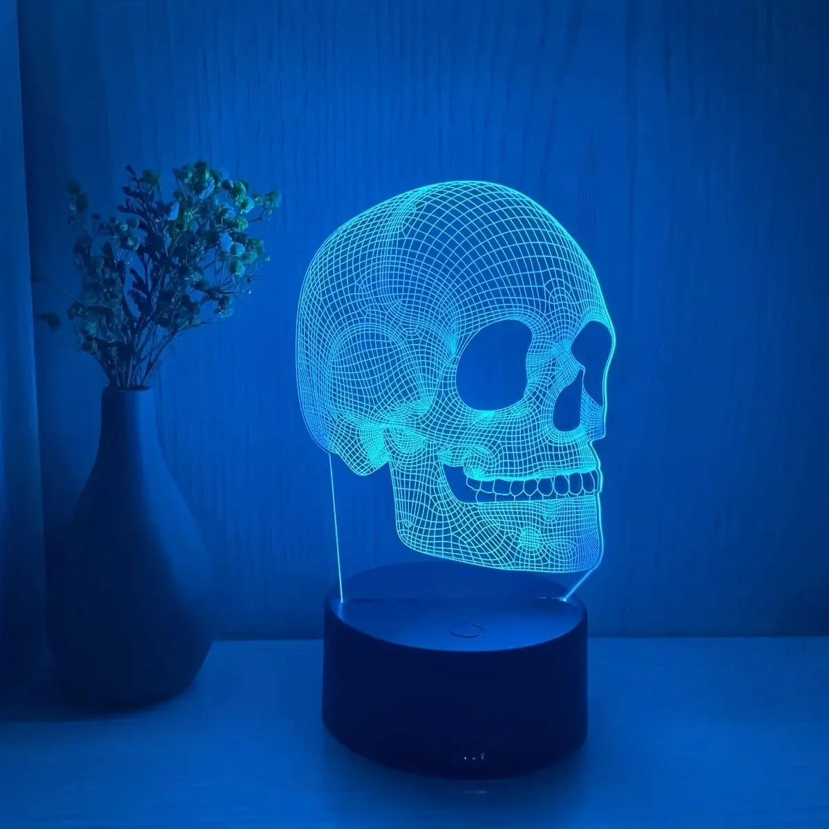 Skull-shaped 3D LED USB night light with blue glow on black base.