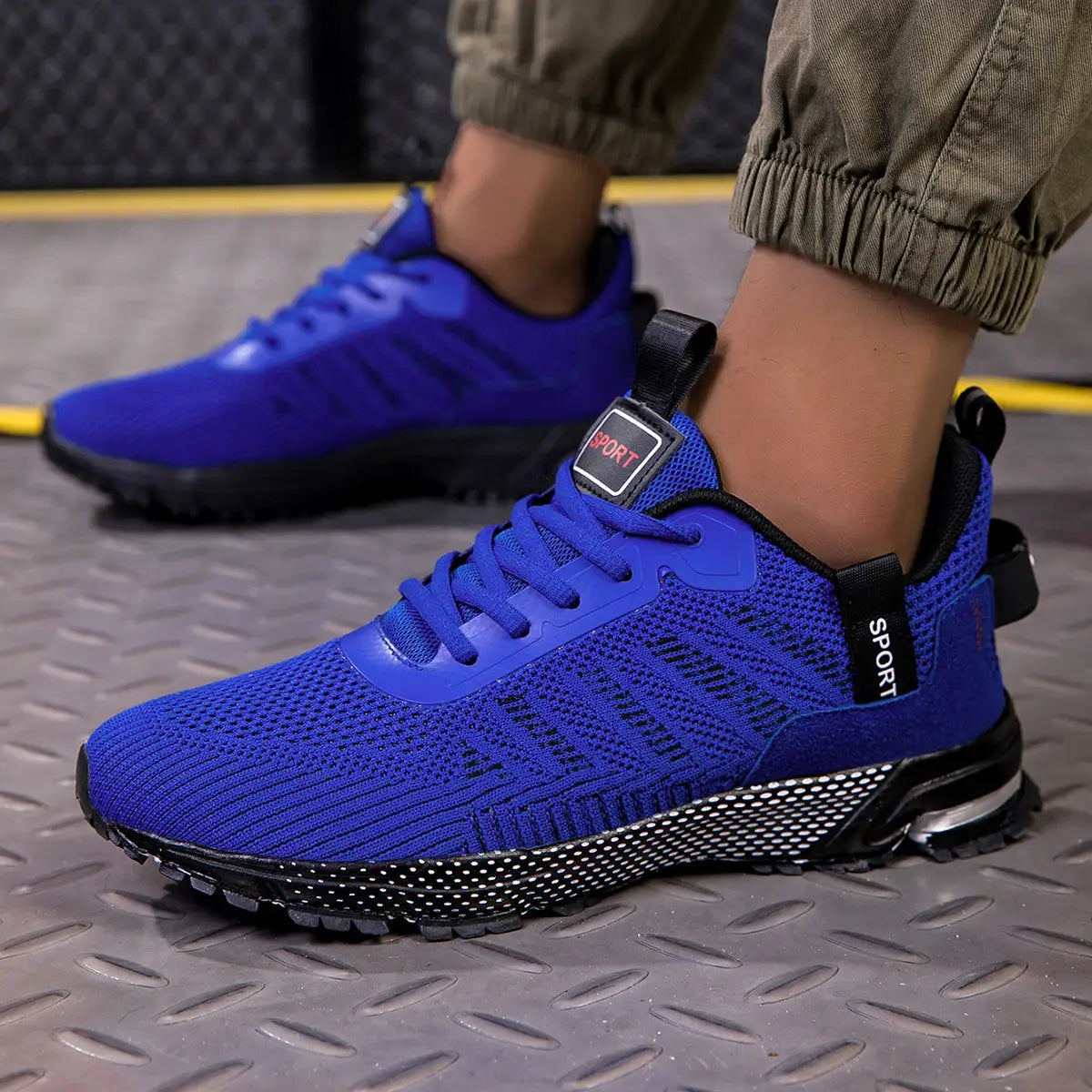 Pair of men's blue running shoes with breathable mesh upper and speckled sole