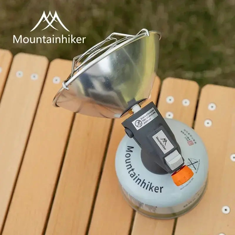 MOUNTAINHIKER portable mini gas stove with metal pan, gray regulator, orange knob; Mountainhiker branding on canister.