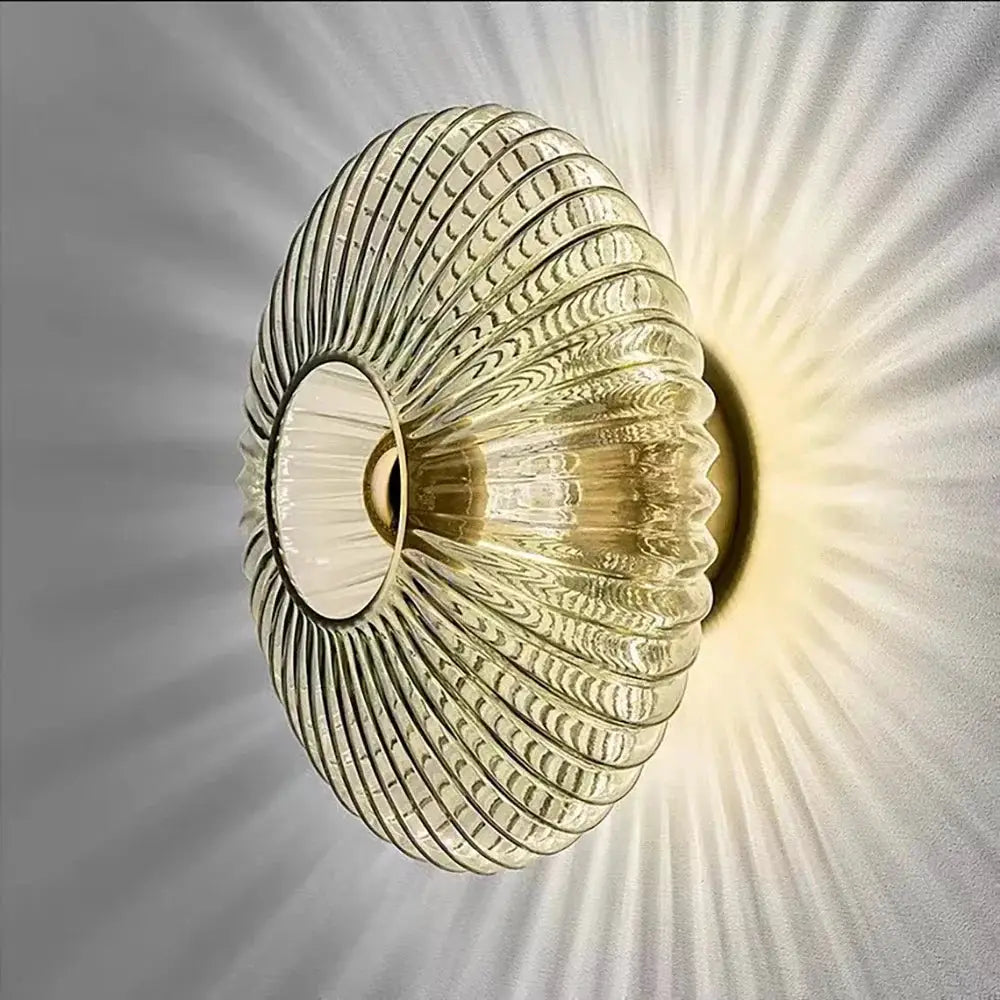 Nordic LED glass wall sconce with ribbed circular shade and warm golden glow