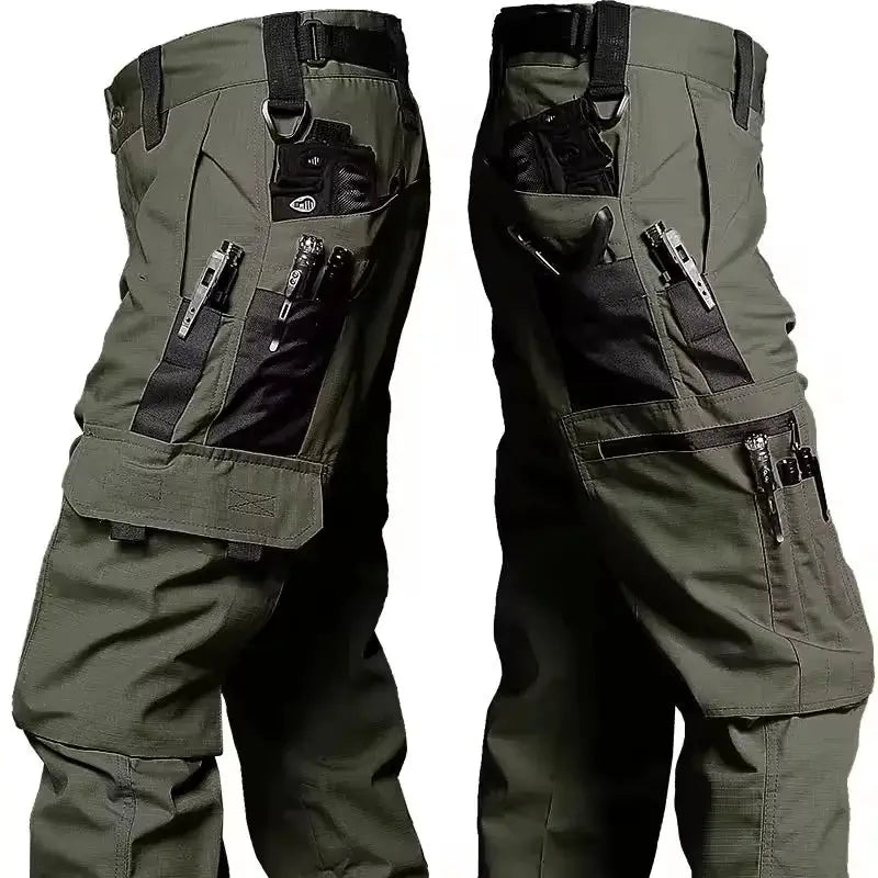 Men's olive green waterproof cargo work pants with multiple pockets and zippers, straight-leg outdoor pants
