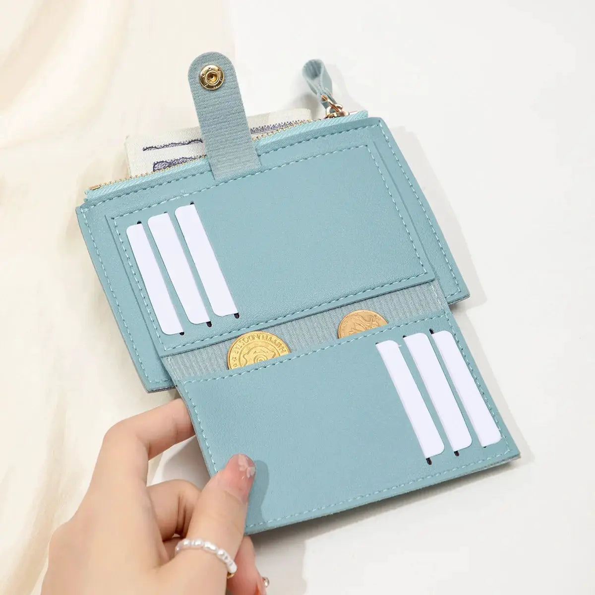 Minimalist women's card wallet in light blue PU leather with multiple card slots and coin pocket