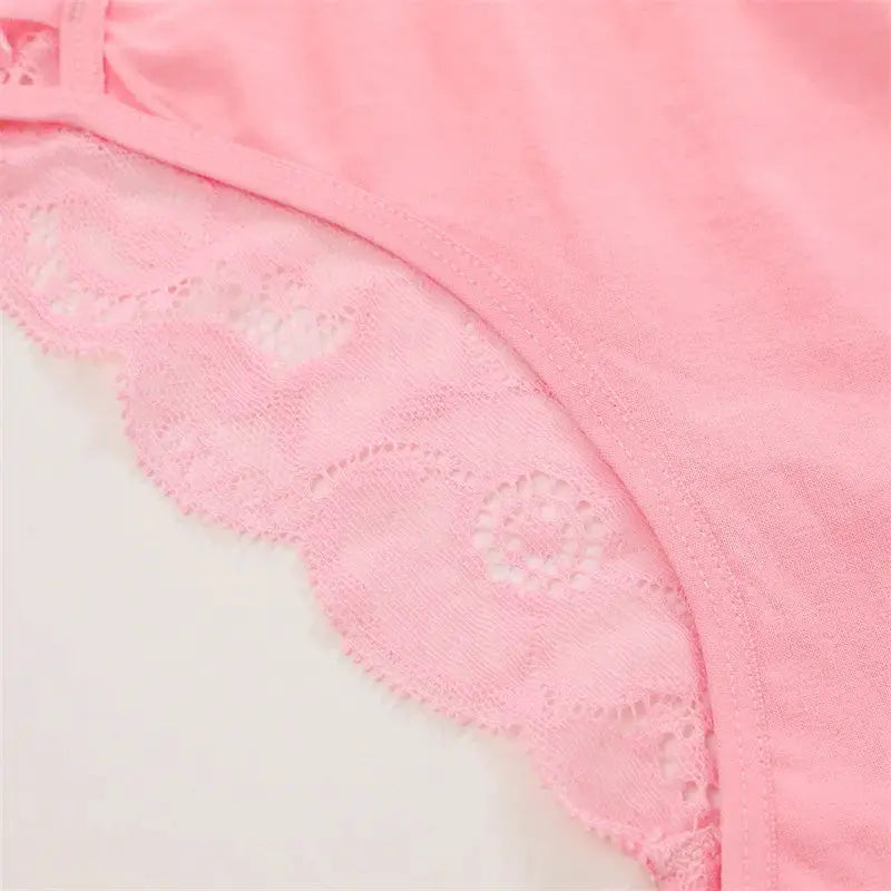 Pink lace panties from Simples Market; low-rise floral lace briefs with sheer mesh panels and elastic straps.