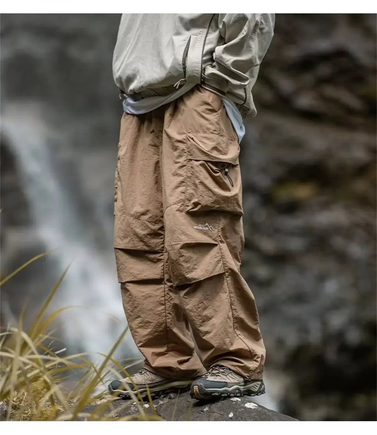 Men's tan waterproof cargo hiking pants with large side pocket and All Mountain logo