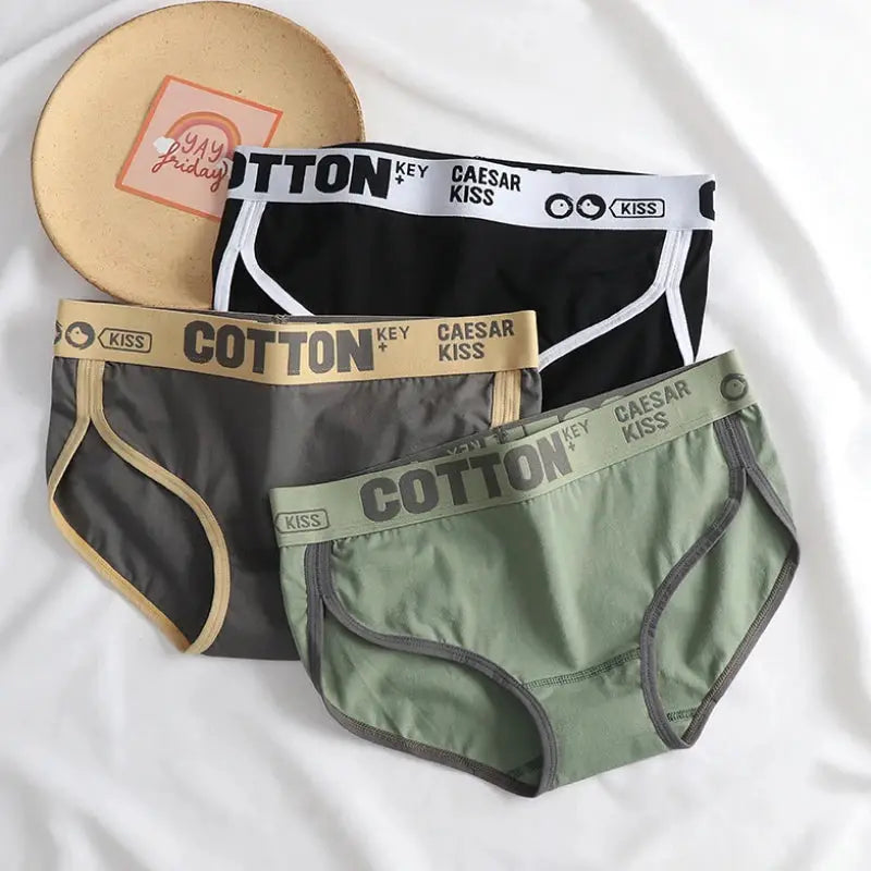 Women cotton briefs three-pack in black, gray, and sage green with seamless design and contrasting waistbands.