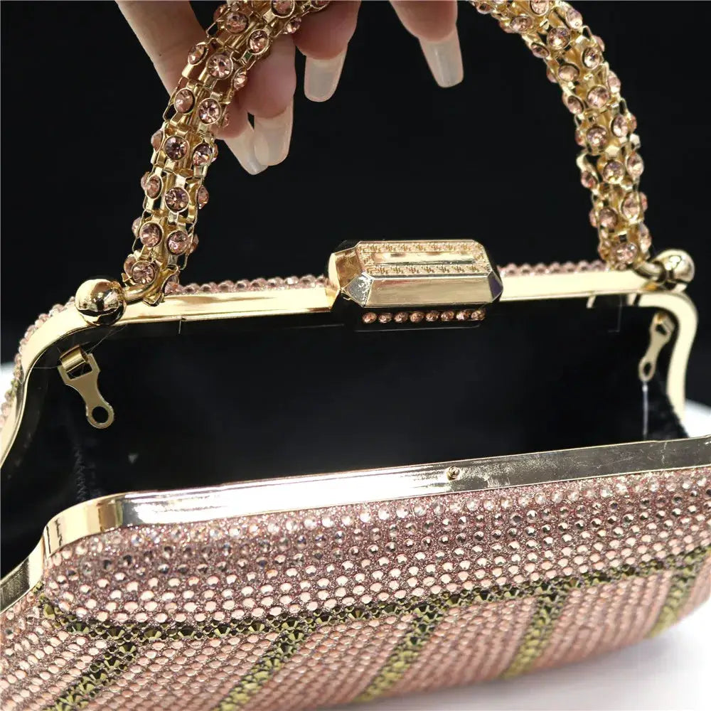 Evening clutch in gold-tone with pink rhinestones and a jeweled long chain handle.