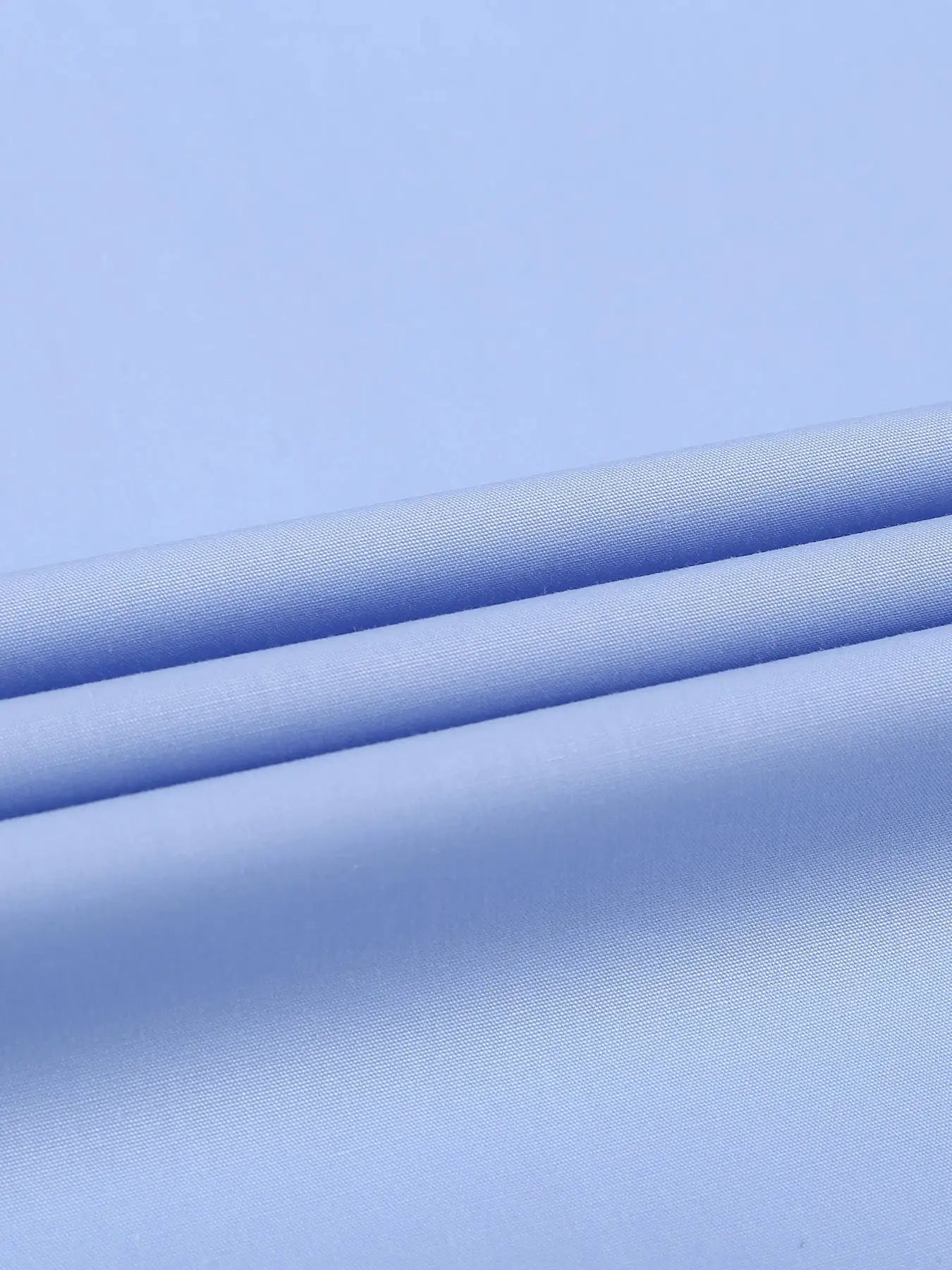 Light blue dress shirt fabric swatches with folded edges