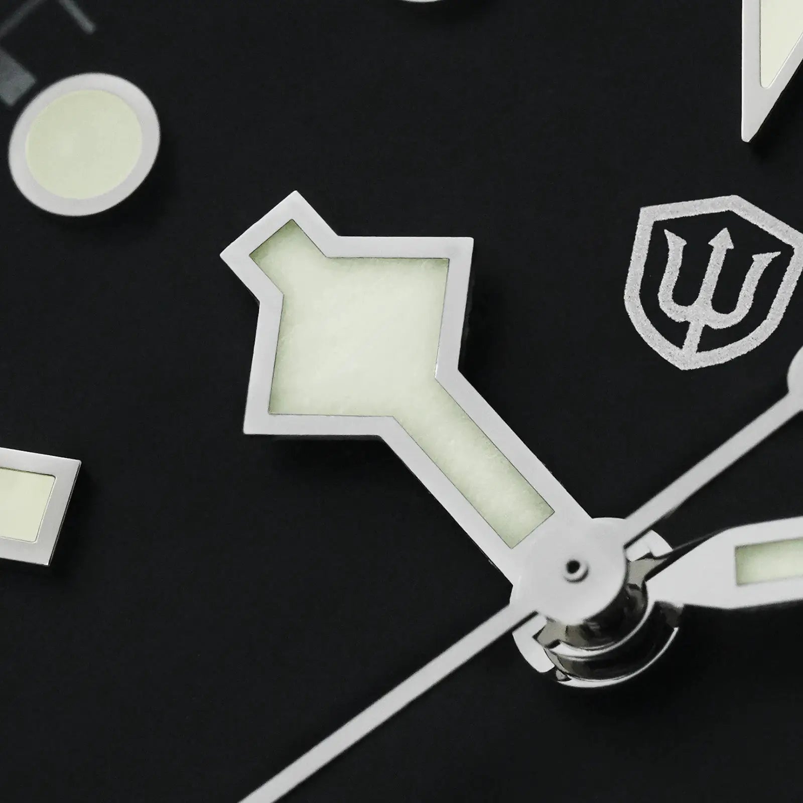 Watch components with luminous panels on a black background; chrome metal frames and angular cutouts.