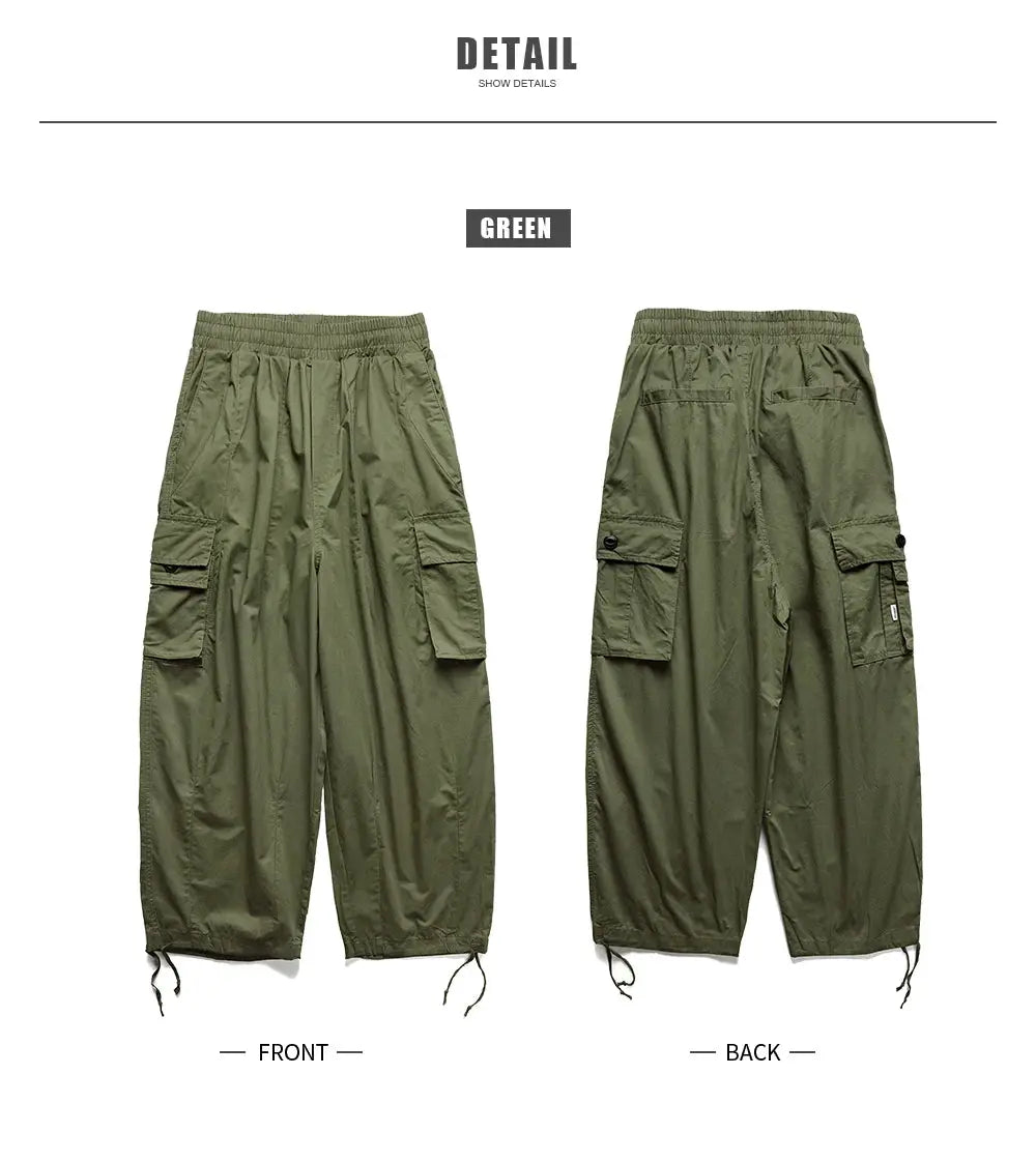 Multi-pocket cargo pants in green by Simples Market; oversized baggy jogger style; front and back views.