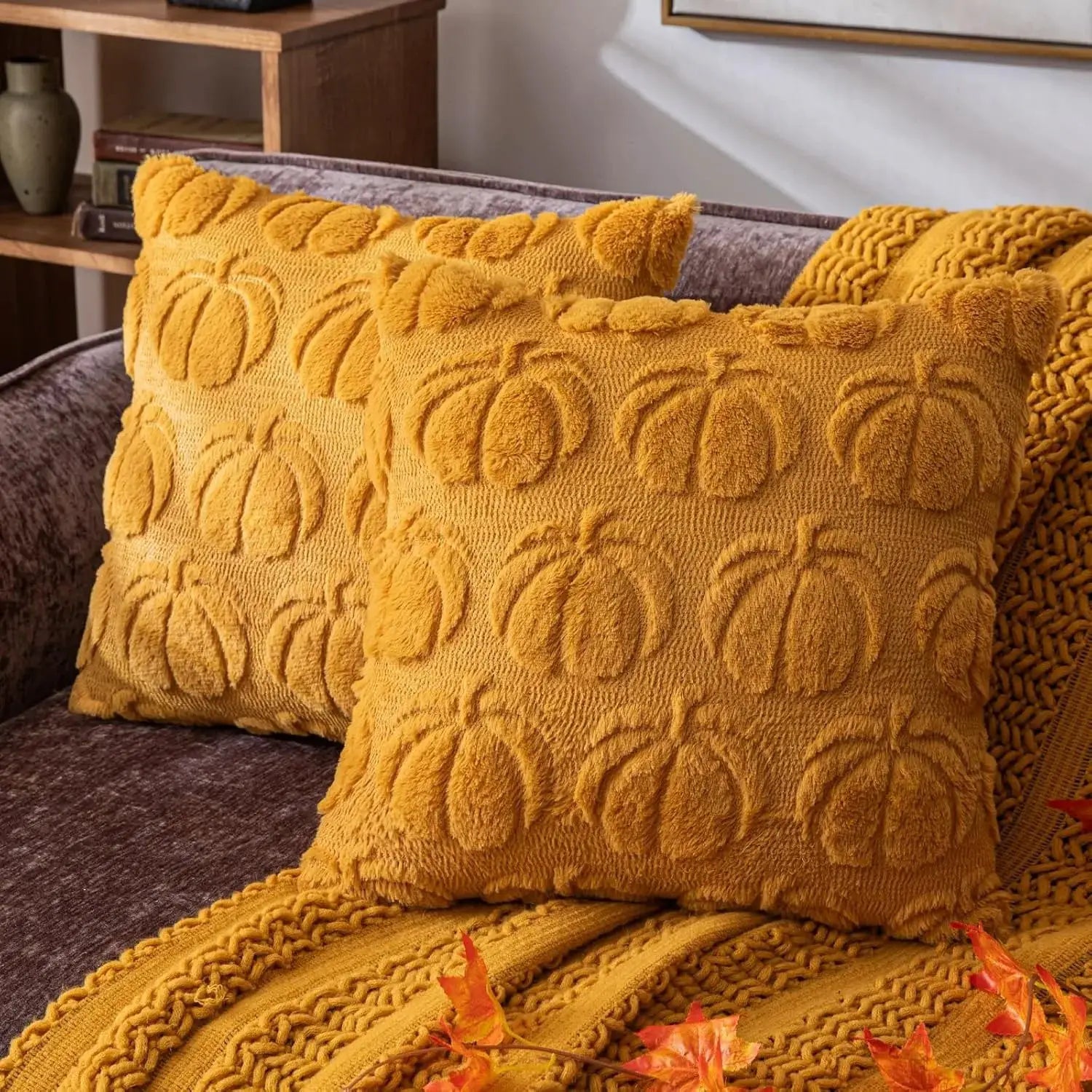 Throw pillows: two mustard-yellow textured with raised pattern on sofa.