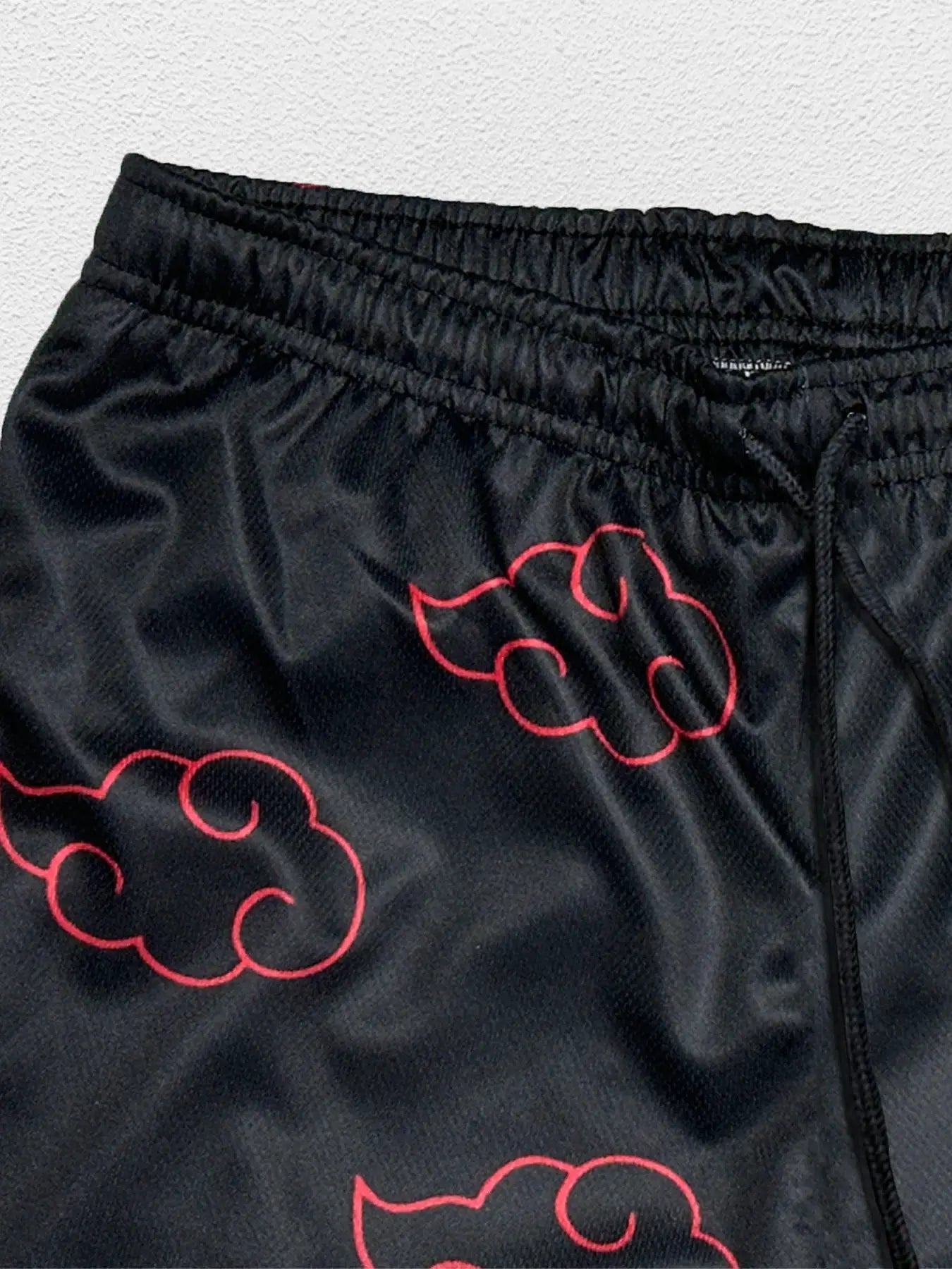 Men's anime running shorts by Simples Market, black with red cloud graphics, elastic waistband, quick-dry fabric.