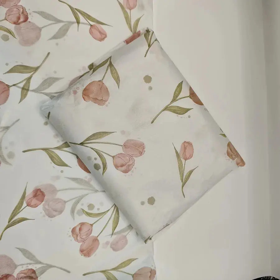Two tissue paper sheets with pink tulips and green leaves on white for gift wrapping