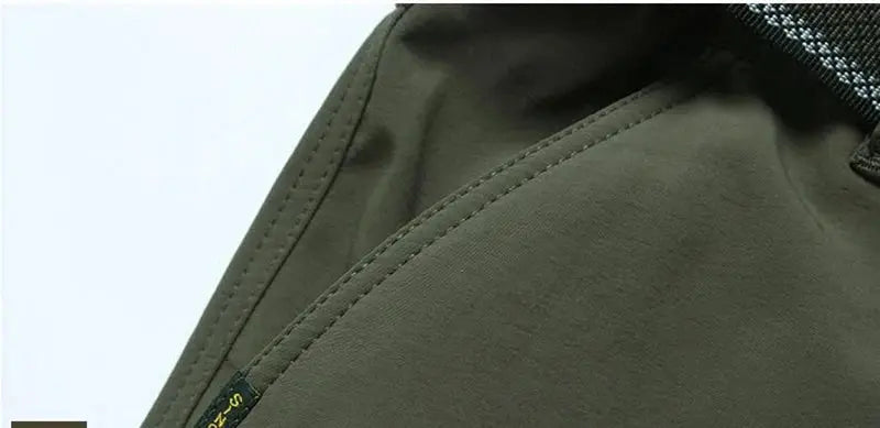 Olive green outdoor work tactical pants fabric close-up with visible stitching Simples Market