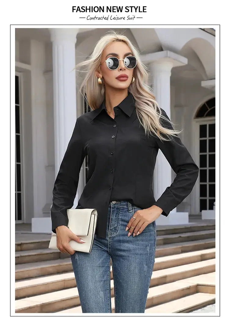 Women's black chiffon button-down blouse with sleeves and turn-down collar, paired with blue jeans and a beige clutch.