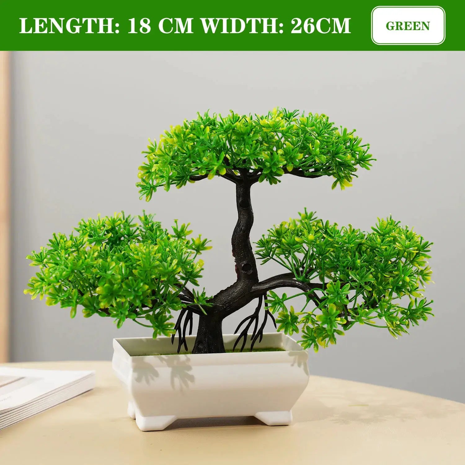 Artificial bonsai tree in white ceramic pot with vibrant green foliage for tabletop decor