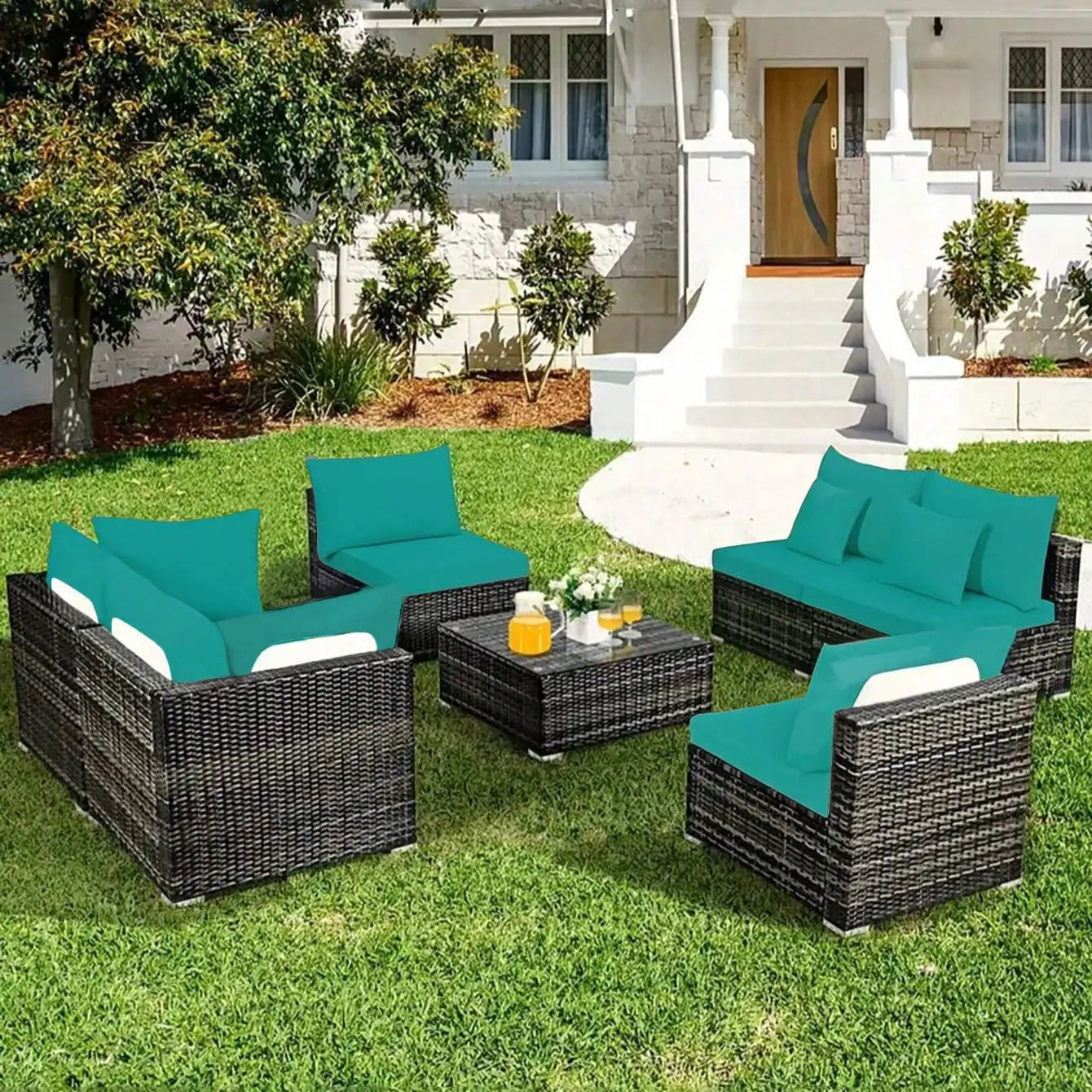Outdoor cushion covers for individual seat cushions; teal cushions on black wicker patio furniture with a table on lawn.