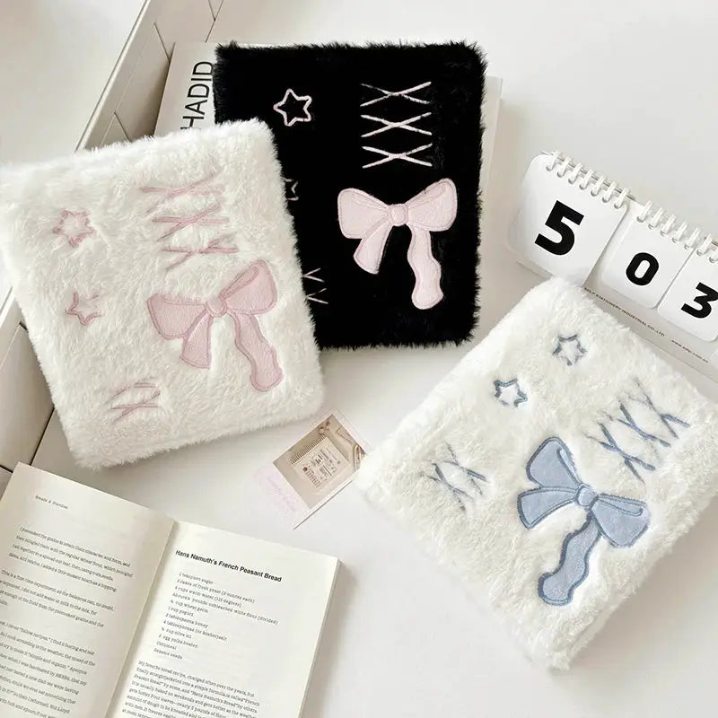 Bow Korea plush A6 binder photocard holders; three fuzzy binders in white with pink bow, black with pink bow, and white with blue bow