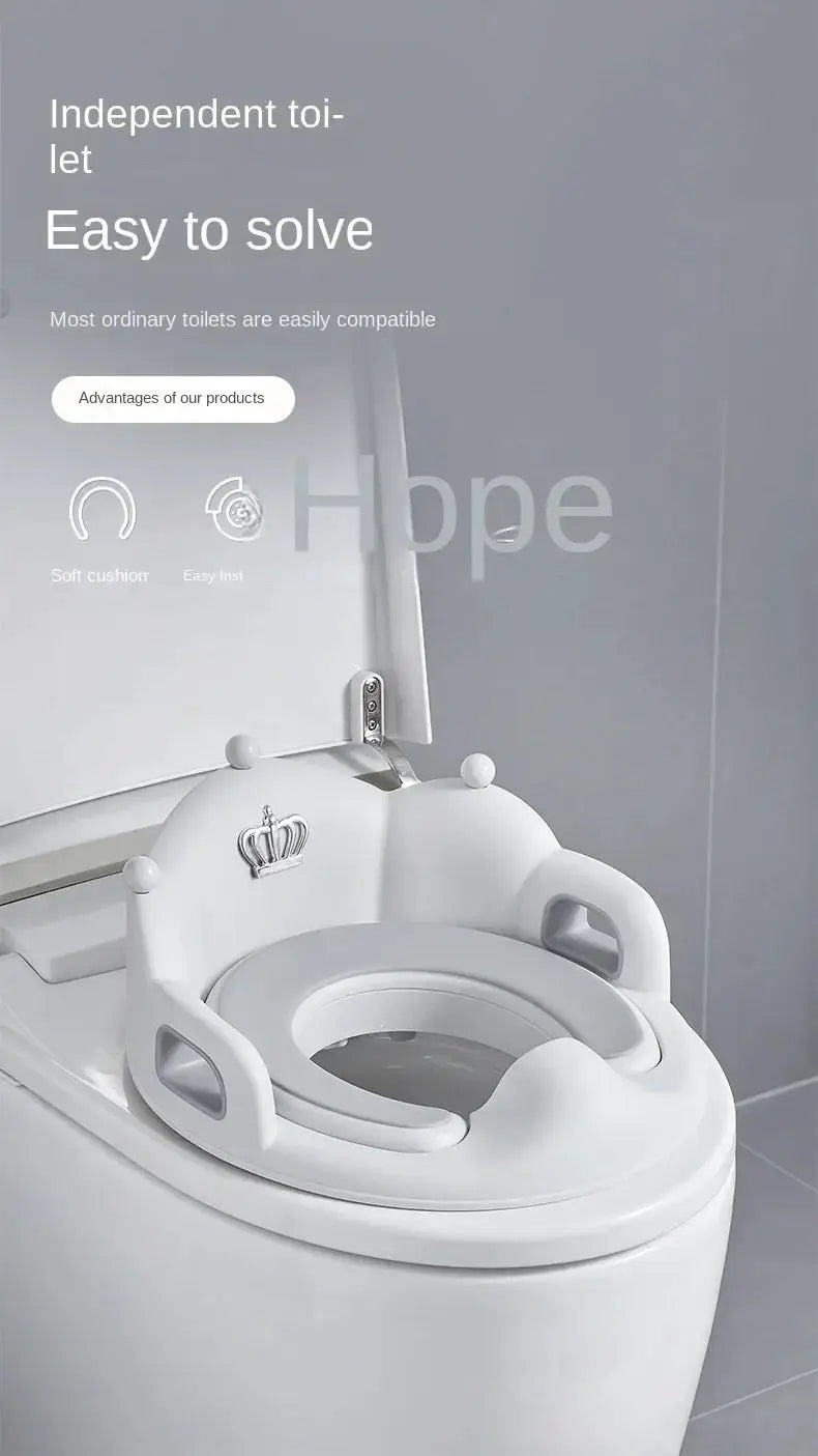 Baby and child toilet seat ring, white cushioned seat with crown crest and side handles, Simples Market