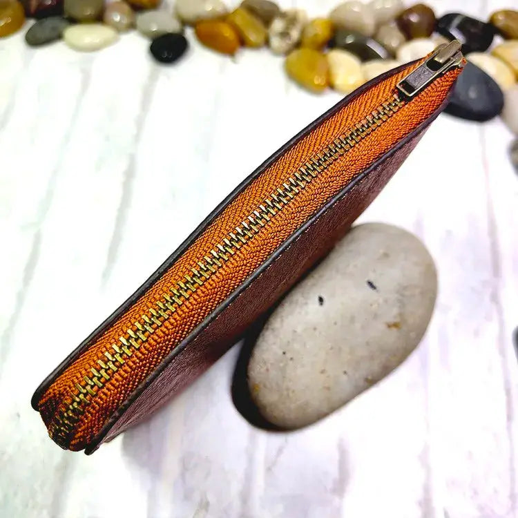 Mini brown leather zipper waist bag with orange lining by Simples Market; slim belt-pack for cards and phone