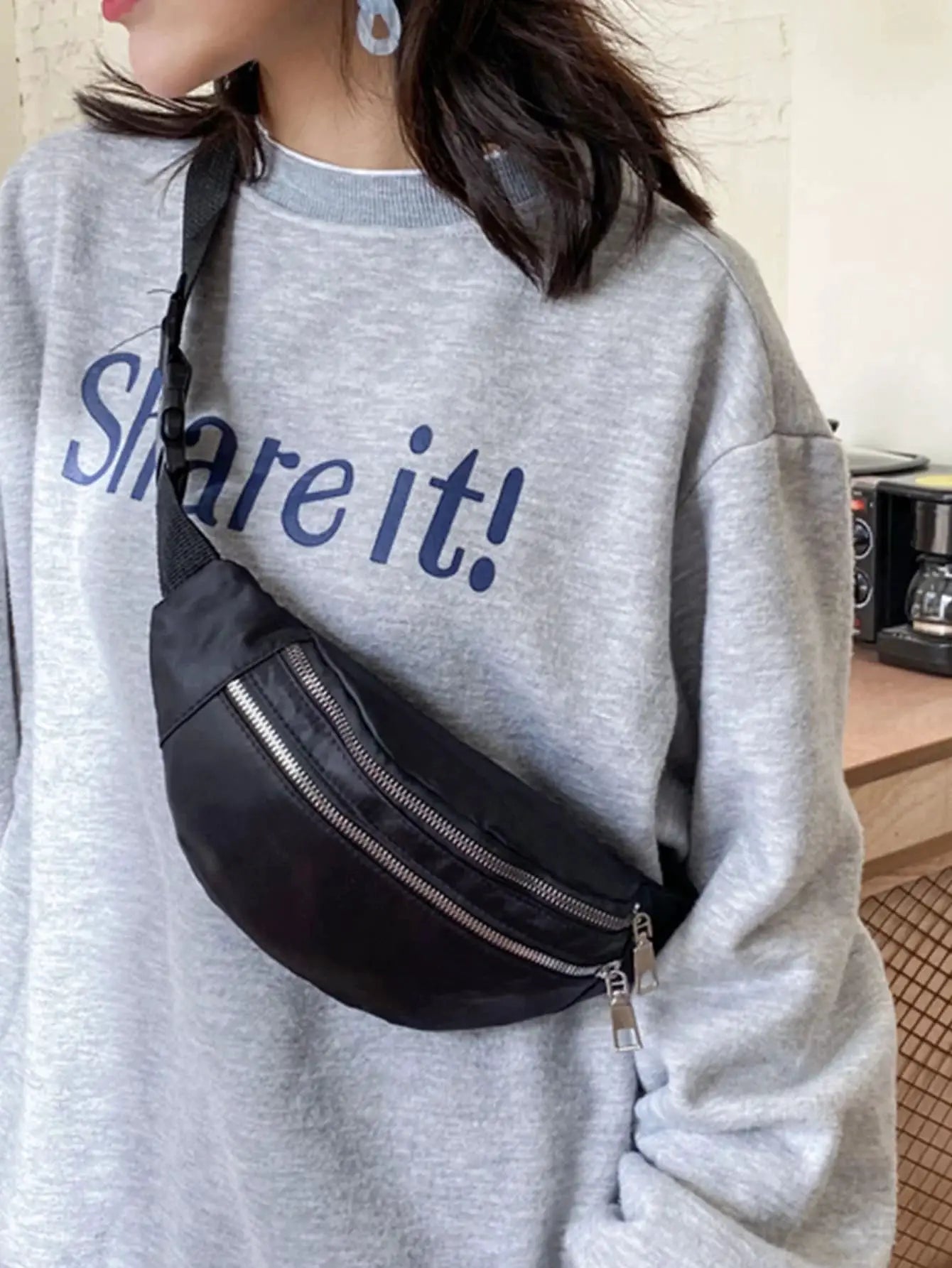 Black nylon fanny pack waist bag with dual zippers and crossbody strap