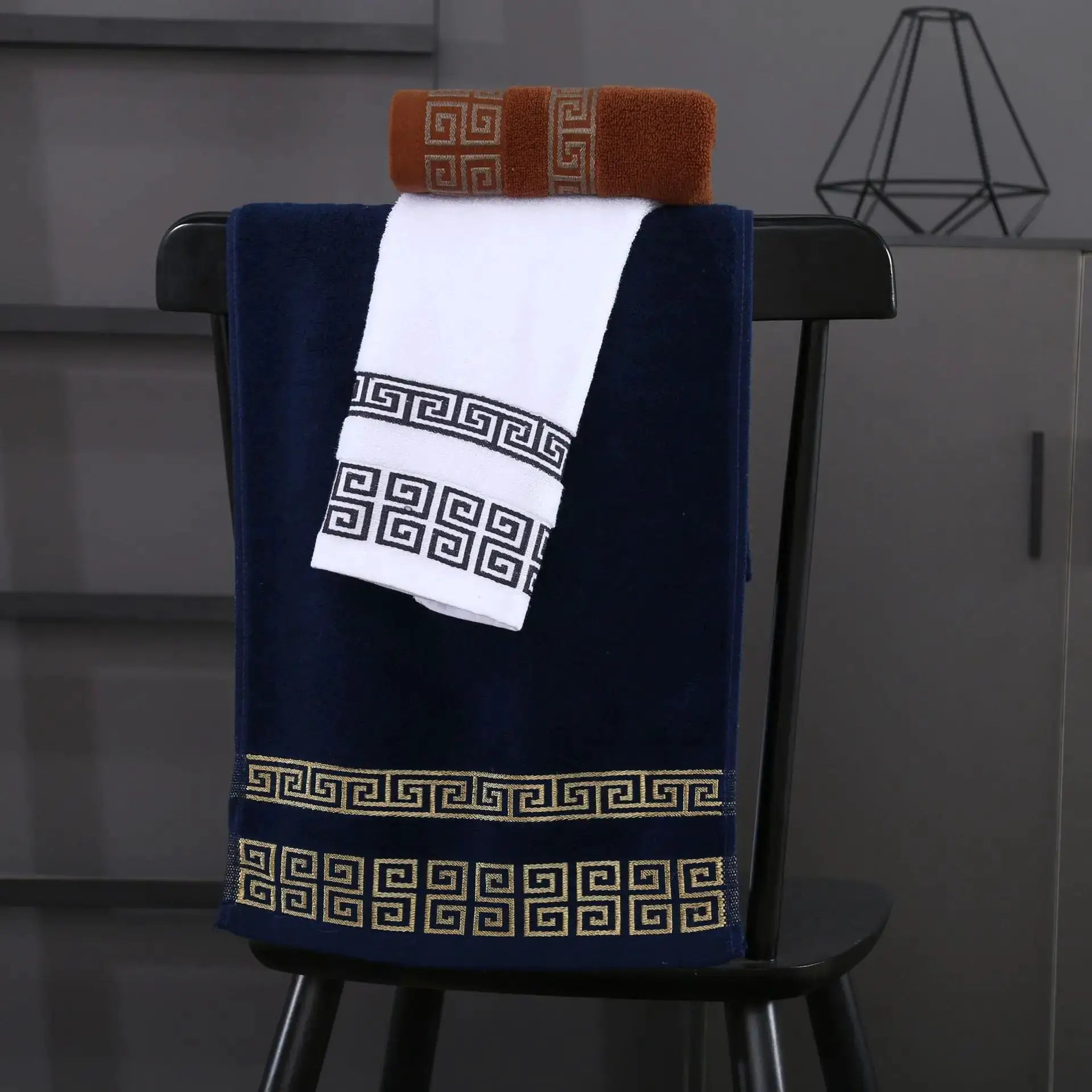 Simples Market 2pc cotton towel set; navy towel with white Greek-key border and white towel with geometric trim