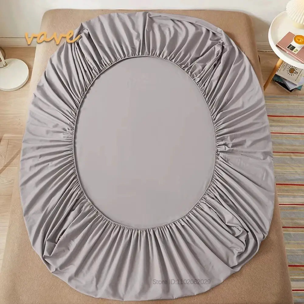 Gray cotton fitted sheet with elastic edges for full-size beds, shown on a mattress.