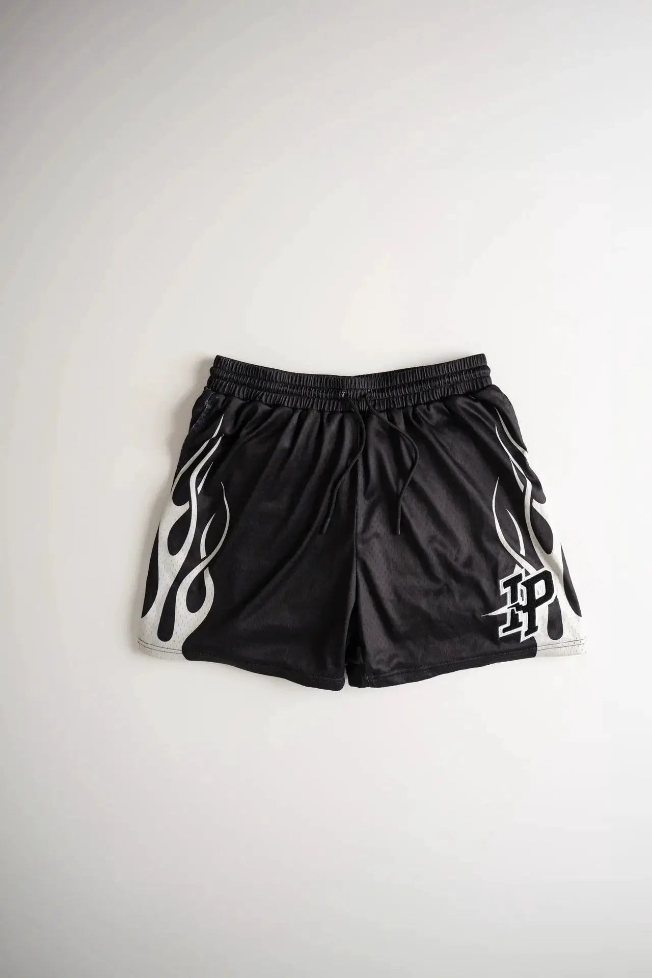 Mens black athletic shorts with white flame side graphics, drawstring waist, breathable quick-dry mesh.