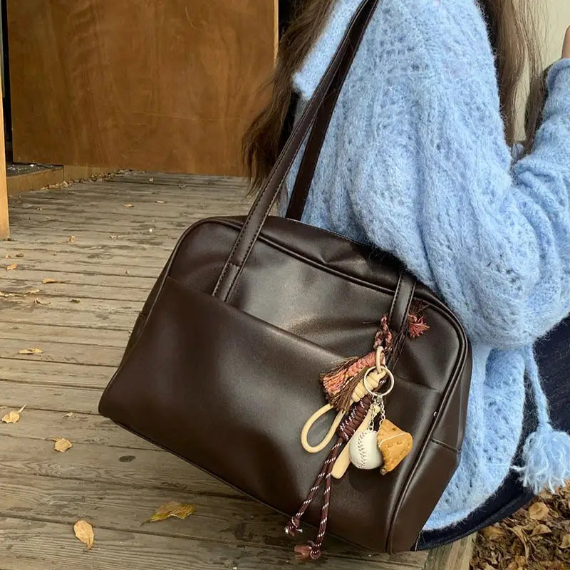 Simples Market brown leather shoulder bag with tassel charms; large-capacity vintage tote.