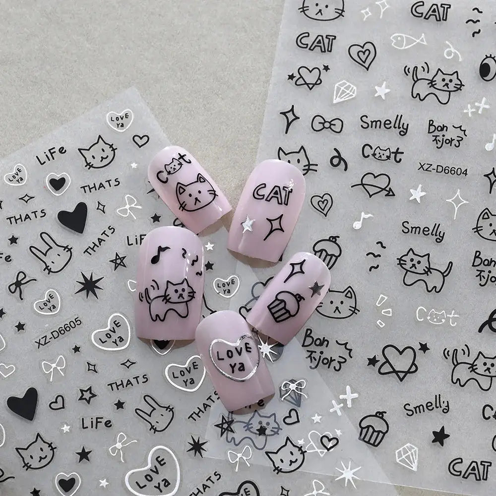 12-sheet cartoon cat nail stickers set on pastel pink nails with cat faces, stars, and hearts