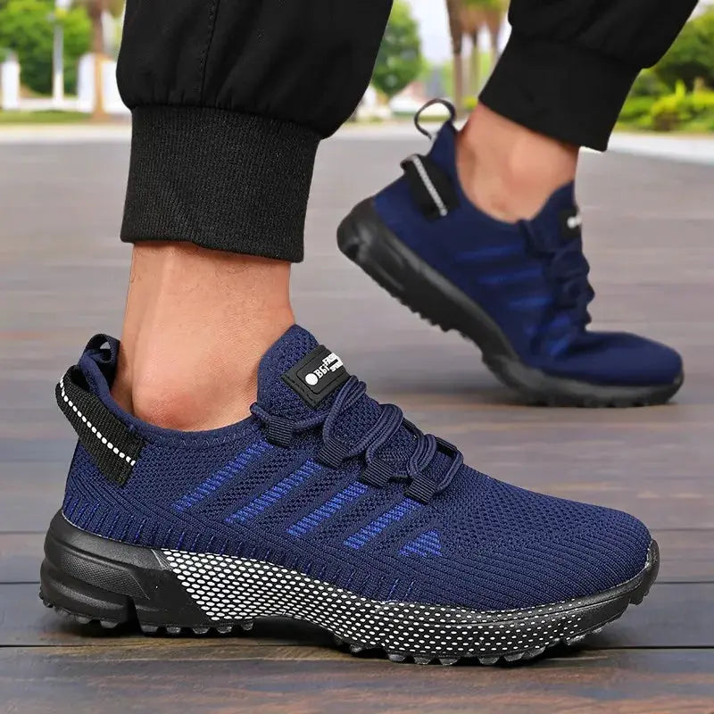 Pair of men's sneakers by Simples Market in navy blue with thick sole and breathable knit upper