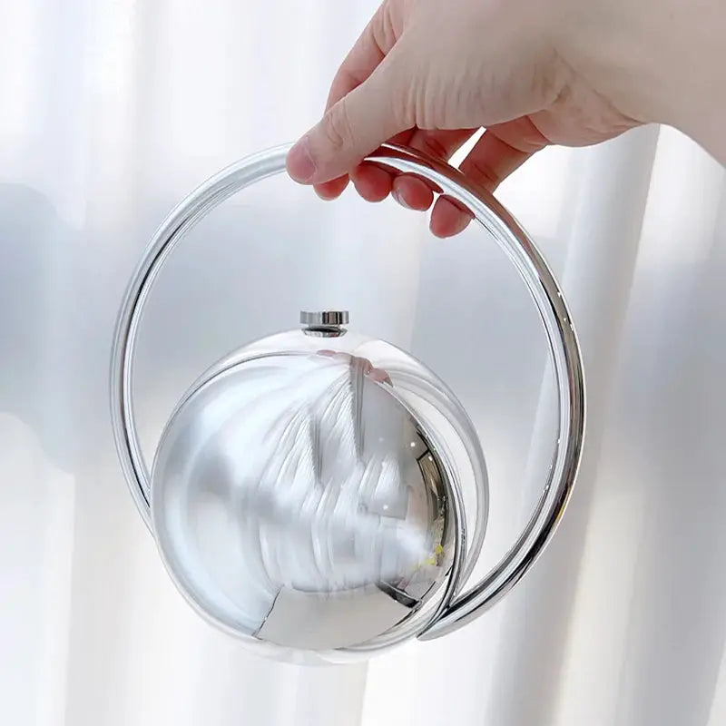 Acrylic evening clutch with ball handle; clear circular design and silver ring handle