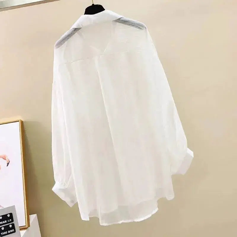 White chiffon blouse, see-through lightweight long-sleeve top with loose fit on hanger