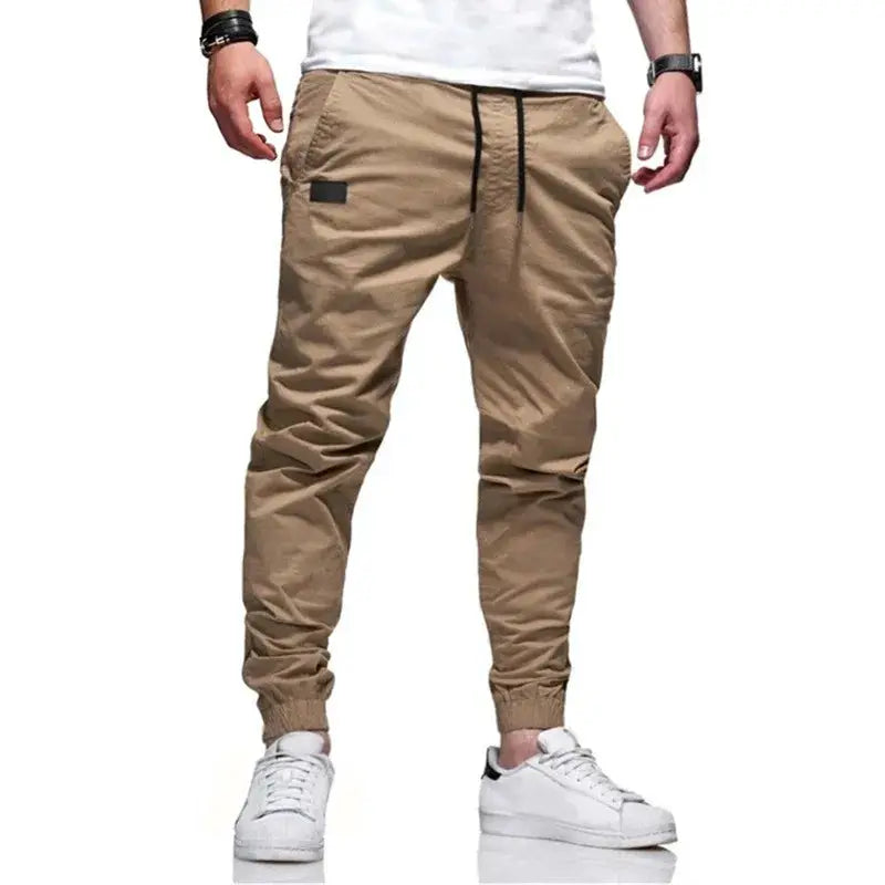 Men's cargo jogger pants by Simples Market, tan with multi-pocket design and drawstring waist.