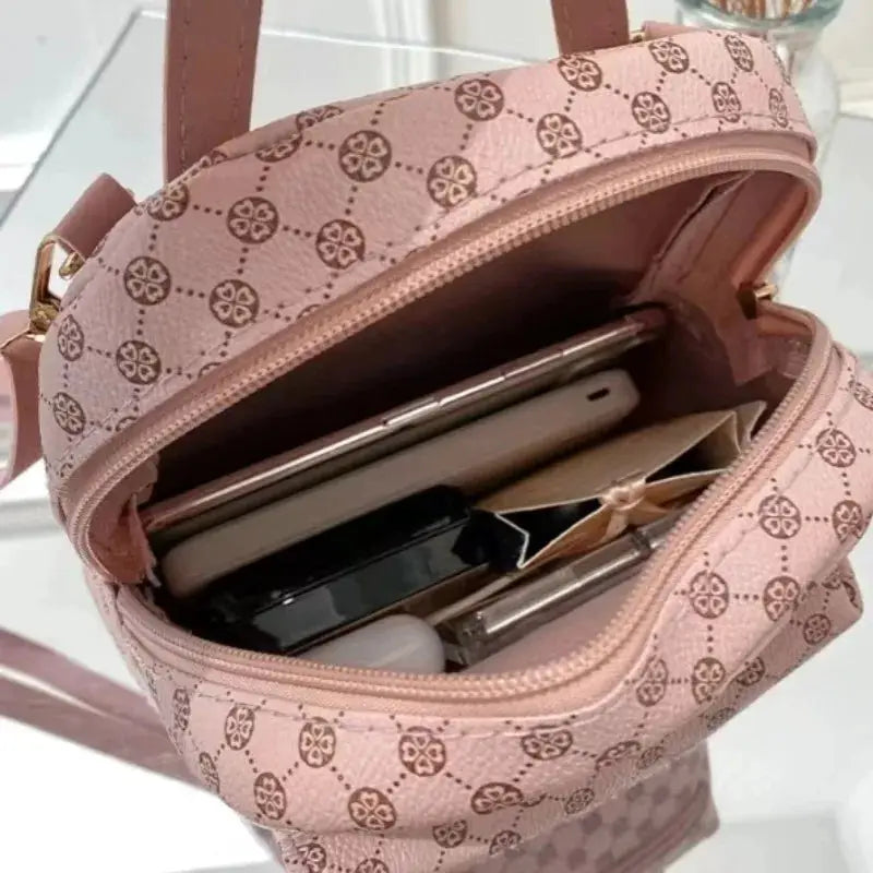 Pink Simples Market backpack, fashion school bag, open with phone and cosmetics inside.