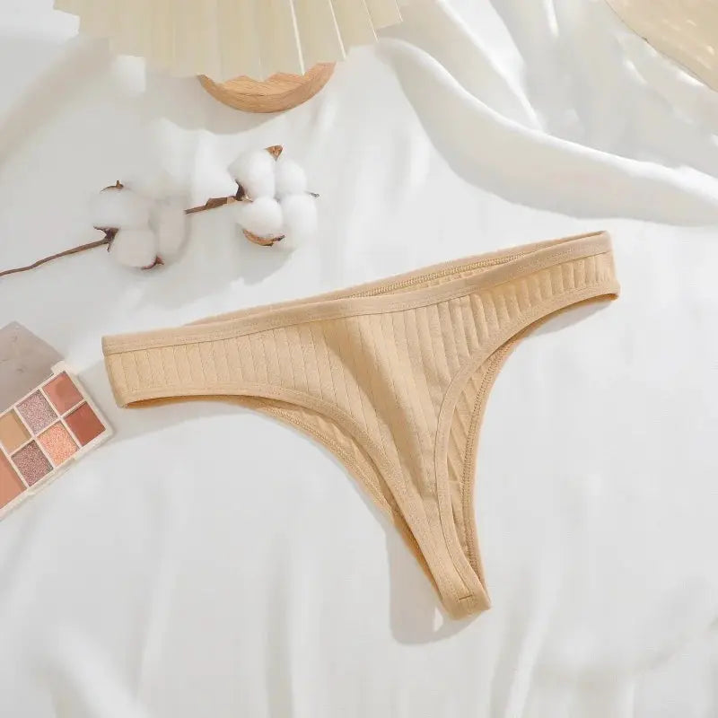 Beige ribbed cotton thong underwear for women, low-waist style.