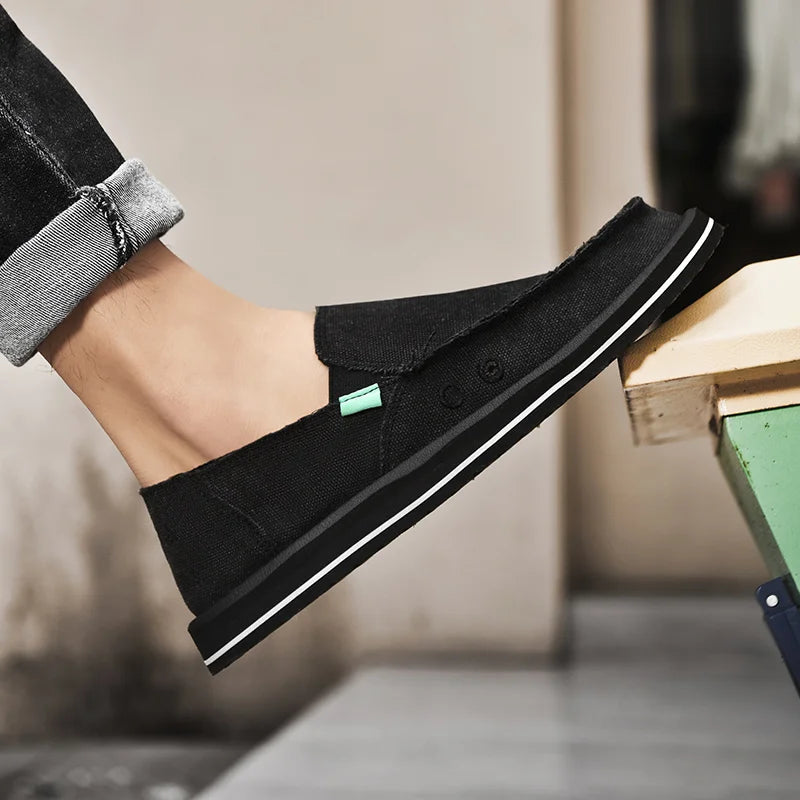 Black canvas casual men's loafers with white stripe sole and teal accent, low-top breathable shoes