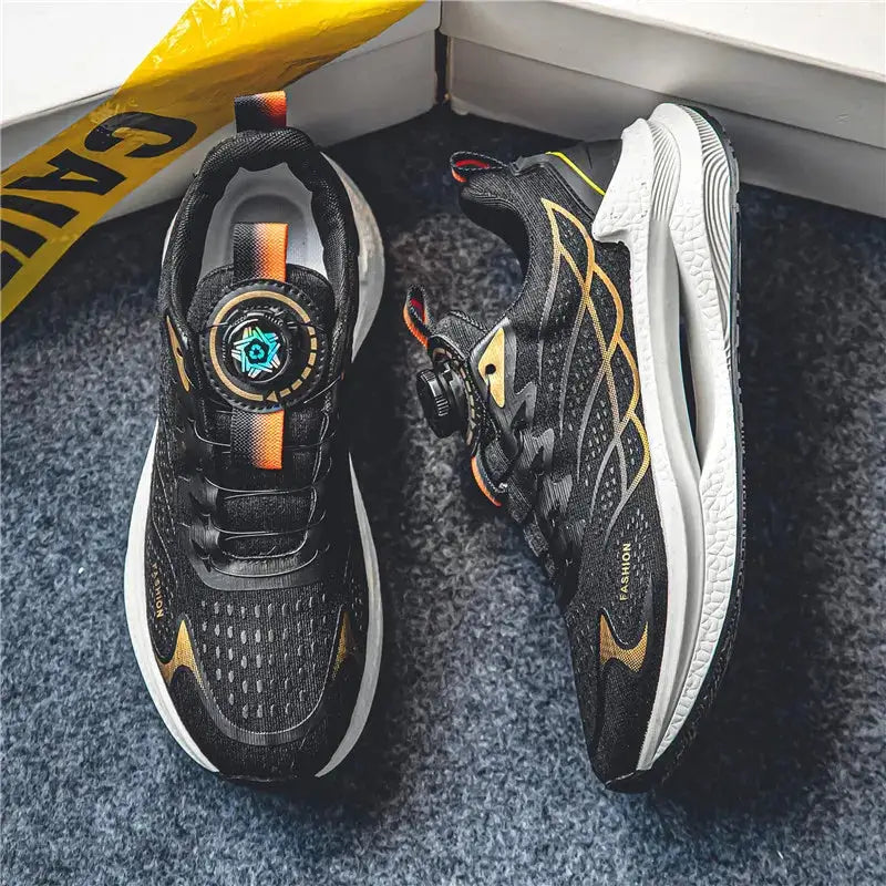 Pair of men's breathable mesh sports shoes; black with gold accents and rotating dial lacing.