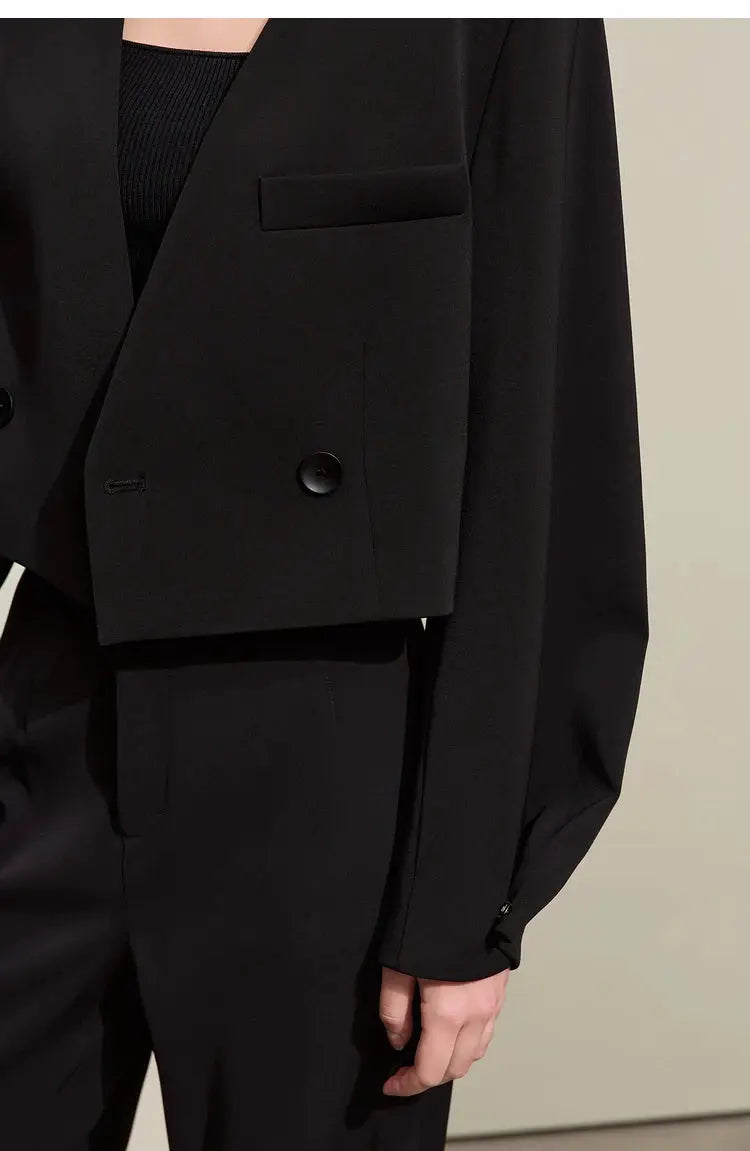 Black blazer jacket with front buttons and pocket, paired with matching black dress pants.