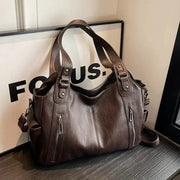 Shoulder bag in brown PU leather with dual top handles and vertical front zipper pockets