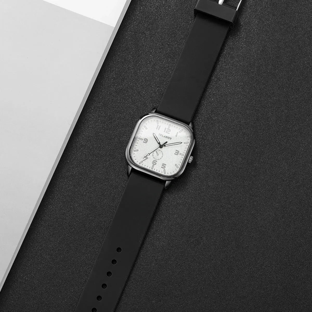 Square-faced quartz watch with black silicone strap and silver case, IRLANDY dial