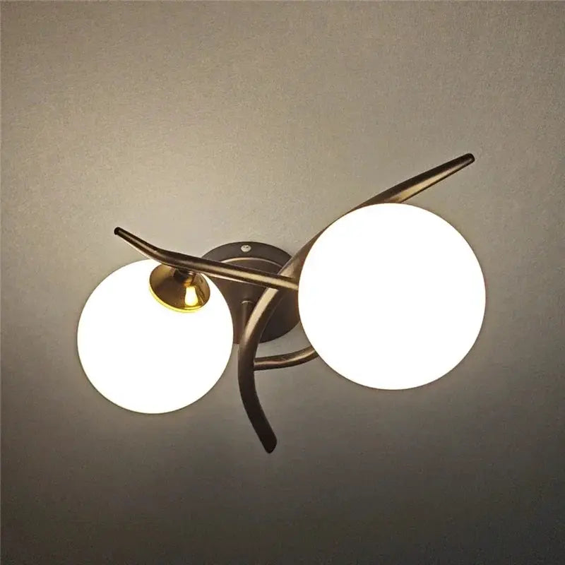 Nordic modern iron wall lamp with two white glass globes and bronze finish, LED G9