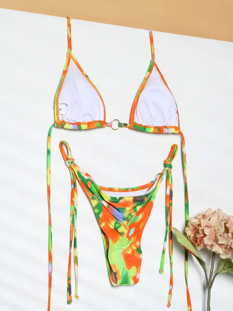 Simples Market women's triangle bikini set with white cups, orange-green tie-dye trim, and string side-ties