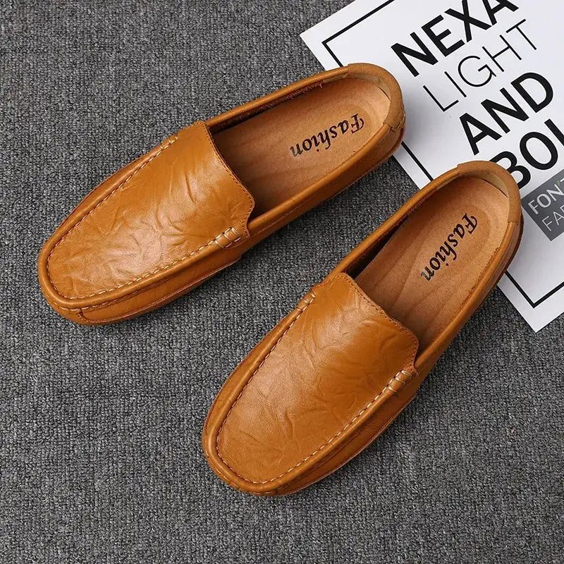 Pair of men's genuine tan leather loafers, slip-on moccasins with breathable casual driving style